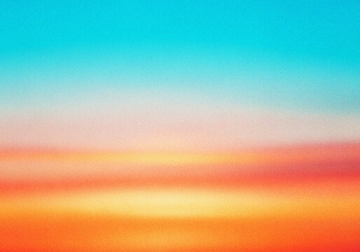 Vibrant sunset horizon with soft blurred color gradients and a subtle grainy finish for artistic projects