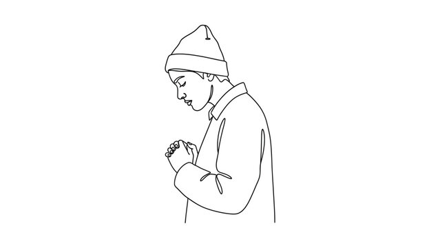 Man wearing a beanie looking down.