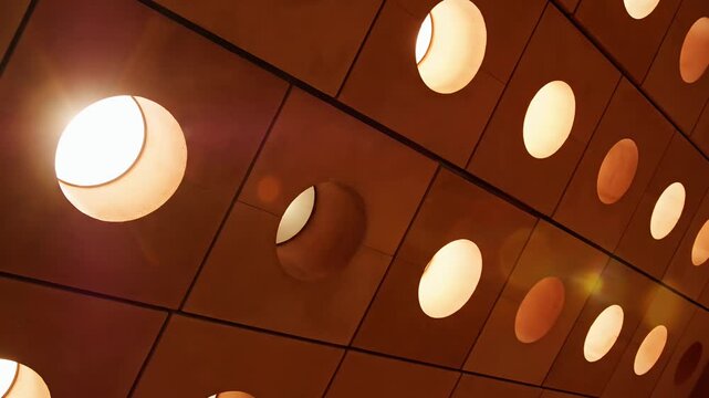 Abstract ceiling design with circular lights and brown tones