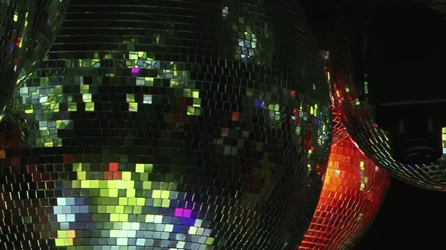 Experience the vibrant energy of a Christmas celebration in a bustling nightclub. Dazzling disco balls reflect a kaleidoscope of festive lights, creating an electrifying atmosphere for dancing.