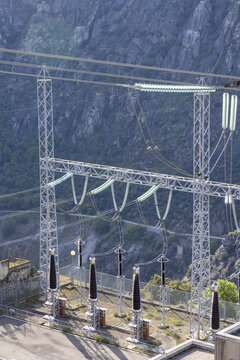View of the Aldeadavila II Electrical Substation with high-voltage insulators and power lines against a steep rocky cliff in Aldeadavila de la Ribera, Castile and Leon, Spain.