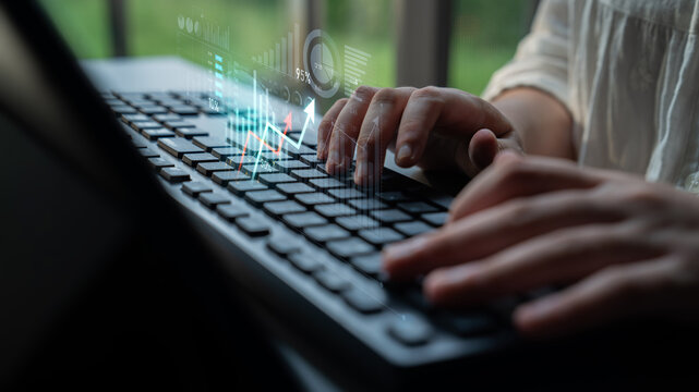 Close-up of hands typing on a keyboard with a digital overlay of growth data, emphasizing technology, productivity, and the modern workspace environment. Scalp