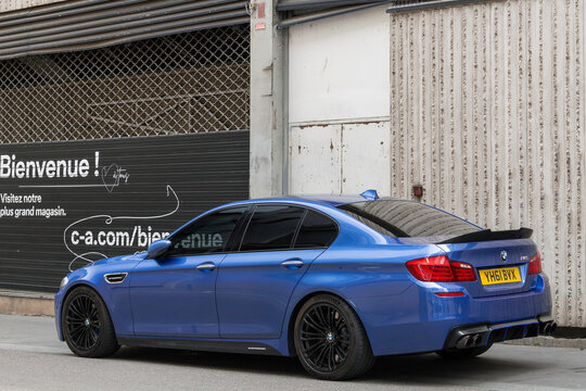 Nancy, France - April 29th 2022 : View on a blue BMW M5 F10 parked on a street.