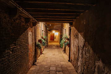 Fototapeta premium Silent Venice street at night,warm lighting and old charm.Historic European city