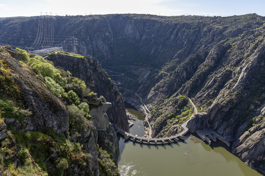 View of the Aldeadavila Dam and Aldeadavila II Electrical Substation nestled within the steep rocky cliffs of the Duero River canyon Aldeadavila de la Ribera, Castile and Leon, Spain.