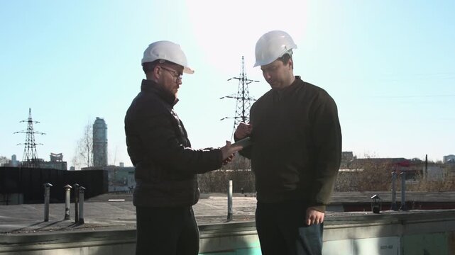 Two Experienced Site Inspectors Review Plans From Rooftops And Provide Explicit Guidance To Team Members. Media