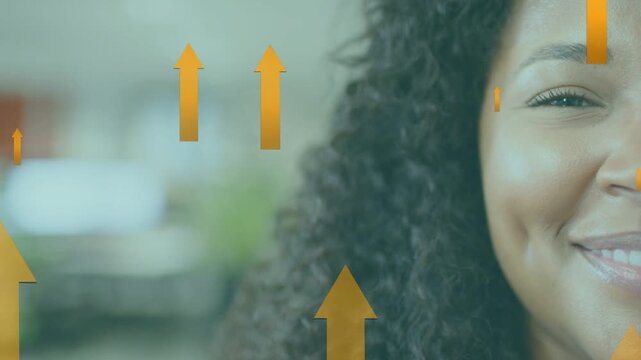 Woman opening eyes smiling in office as animated arrows rising across face showing business growth