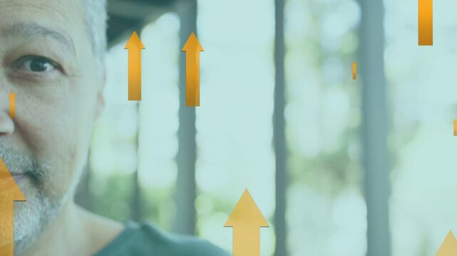 Mature man opening eyes and smiling while orange arrows rising past face, signaling finance growth