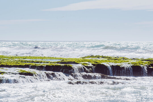 Crashing waves over the emerald green reefs of Ain Beida, a hidden coastal gem in Dakhla, Morocco.
