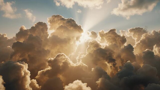 Golden sunlight breaking through towering clouds in a dramatic heavenly sky