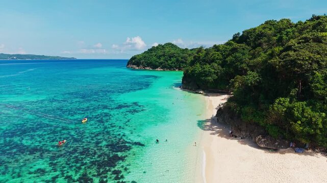 Drone flying forward over Puka Beach Boracay Philippines, turquoise water
