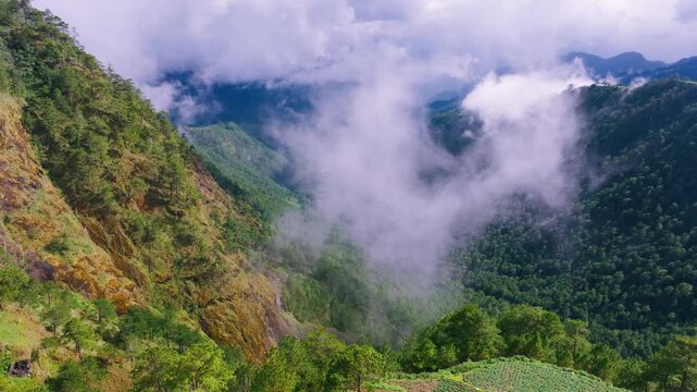 Slow drone pullback at Halsema Highroad reveals terraces and misty valley below