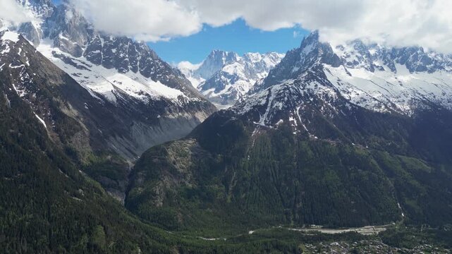 Wide cinematic drone panorama of the Mer de Glace glacier surrounded by dramatic snowy peaks and alpine landscapes in the Chamonix valley, France, captured from above in the heart of the French Alps.