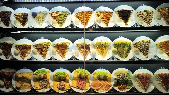Detailed plastic dessert replicas arranged as menu examples in food display