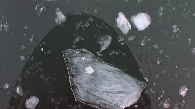 Mighty vessel pushes through dense ice fragments, crafting clear way across frigid surface of Arctic Ocean. This powerful journey unfolds off coast of Norway, revealing raw polar strength.