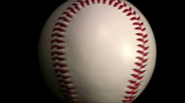baseball the ball spins on black background