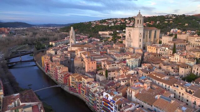 Girona at Sunset time, Aerial Shot. Fly over the Historical Center with Colorful Houses and Cathedral of Girona, Spain.