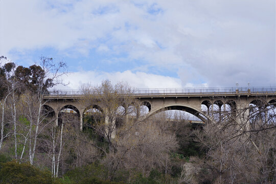 Colorado Street Bridge in Pasadena, California, photographed on an overcast day. The modern 134 Freeway can be seen in the background.
