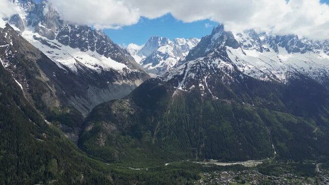 Wide cinematic drone panorama of the Mer de Glace glacier surrounded by dramatic snowy peaks and alpine landscapes in the Chamonix valley, France, captured from above in the heart of the French Alps.