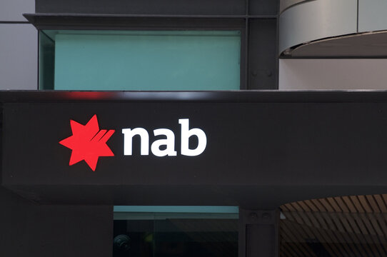 Illuminated NAB (National Australian Bank) sign logo at building entrance in Brisbane