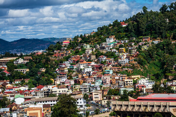 Fototapeta premium Hillside residences in Antananarivo clustered on a steep green slope