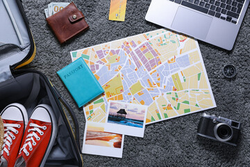 Planning trip. Laptop, camera, map and travel accessories on floor, flat lay © New Africa