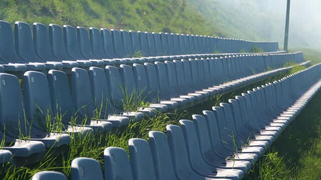 Empty spectator seats symbolizing absence of fans at stadium