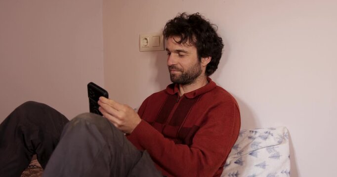 Man taking selfies and having fun on bed