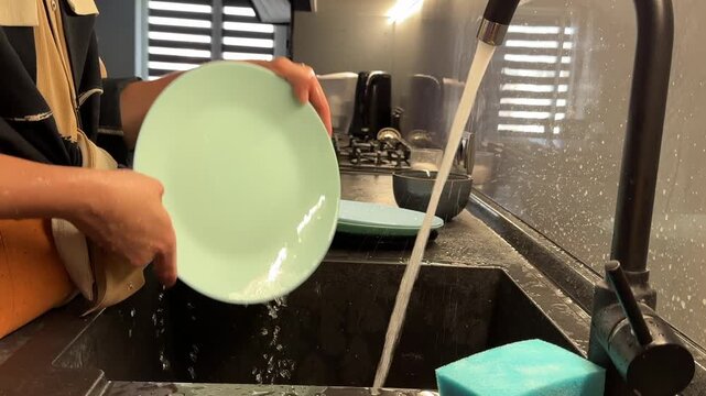 Roommates Washing Plates Carefully. Neat Kitchen With Systematic Rinsing And Stacking Of Plates