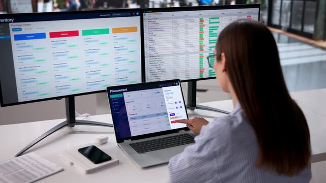 Procurement Manager Reviews Supplier Data On Multiple Screens