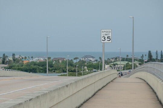 Coastal Bridge Pedestrian Walkway Towards Clearwater Florida with 35 MPH Speed Limit Sign and Ocean View