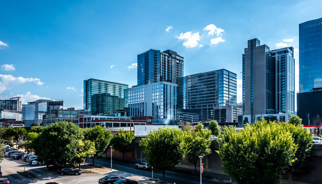 Nashville Tennessee Downtown Cityscape with Modern High Rise Buildings Highway Traffic and Urban Development Under Blue Sky
