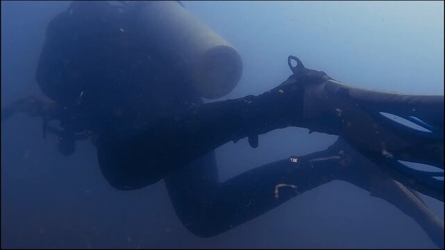 Scuba diver in low visibility high current open ocean on dive