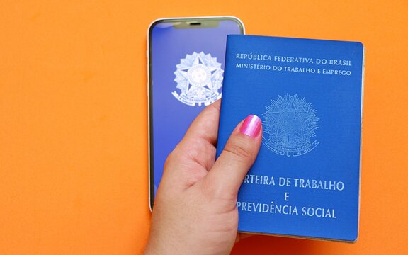 Salvador, Brazil - May 8, 2026: Brazilian Work Card (Carteira de Trabalho do Brasil) on orange background. Formal job, CLT concept. 