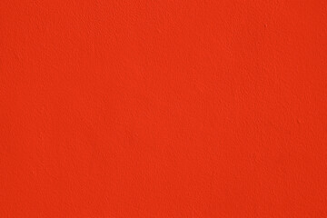 Fototapeta premium Background of natural red orange stucco in plaster cement texture lined pattern or stone in color Textured illuminated wall fence surface blend of warm sunny tones backdrop