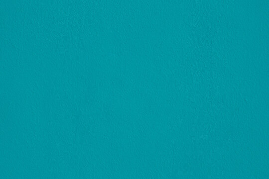 Background of natural light blue stucco in plaster cement texture lined pattern or stone in color Textured illuminated wall fence surface blend of cyan tones backdrop