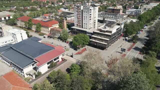 Spring day panorama of central town square with green trees, Vrbas, northern Serbia.