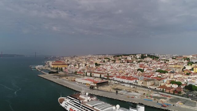 Cruise boat on the banks of the Tejo River with the historic city of Lisbon in the background.