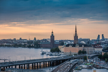 Fototapeta premium Stockholm Sweden Skyline with City Hall Stadshuset and Riddarholmen Church at Sunset with Bridges and Waterfront Cityscape