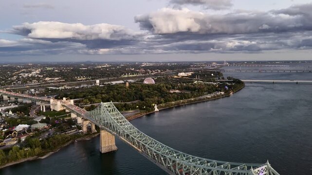 Jacques Cartier Bridge over the Saint Lawrence River at sunset, Montreal, Quebec, Canada skyline and dramatic clouds. g.