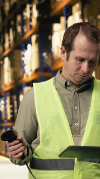 Vertical Video Professional staff scanning barcodes during order fulfillment process. Warehouse management system overseeing inventory for reliable e-commerce shipping and global delivery operations.