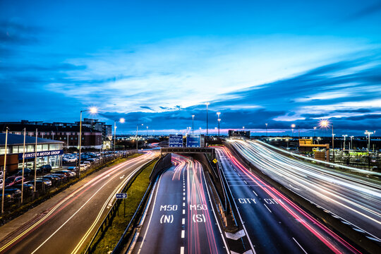 Joe Williams Bridge in Dublin Ireland at Blue Hour with Traffic Light Trails and Urban Highway Cityscape