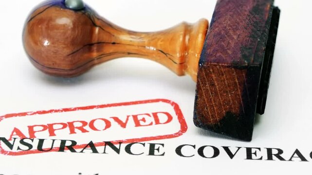 Approved Insurance Coverage Document with Wooden Rubber Stamp