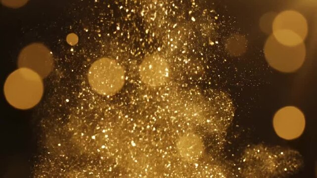 Falling particles create rich gold sparkles in dark background with highlights of glitter and shine