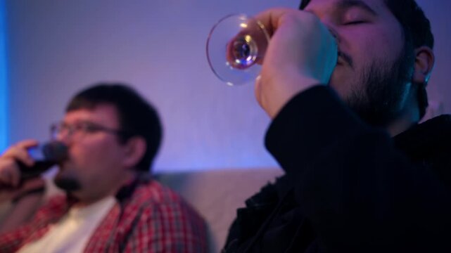 Serene wine tasting in living room. Portrait of person quietly appreciating drinks red wine in glass with ornament. A caucasian adult man in tranquility savoring their wine with friend at evening vibe