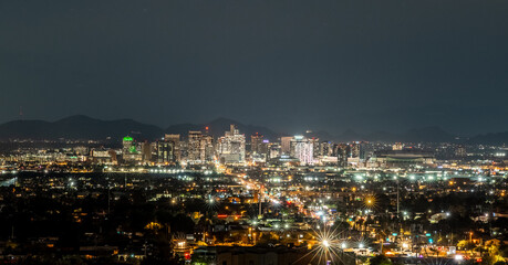 Fototapeta premium Phoenix Arizona Skyline at Night with Downtown City Lights and Urban Landscape Viewed from Elevated Perspective