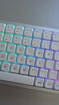Overhead pan of mechanical keyboard keys with rainbow colorful led lights