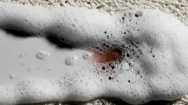 Abstract 4K Seamless Loop of Sudsy Bubbles Forming Over a Textured Surface in Soft Color Palette for Creative VFX and Background Use