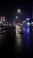 Fototapeta premium Rain-soaked city street at night