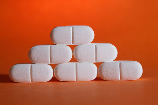 Pile of pills on orange background